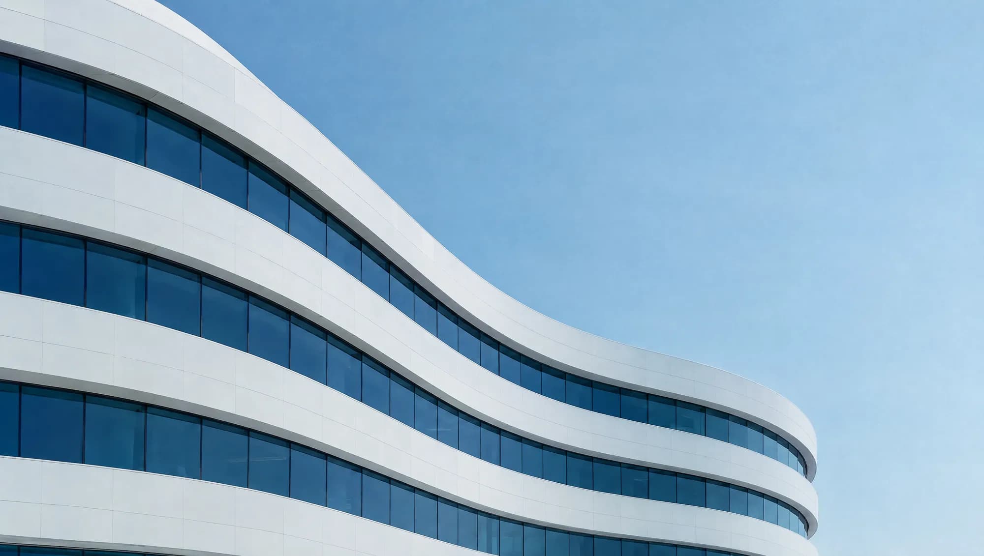 Curved white facade with navy glass
