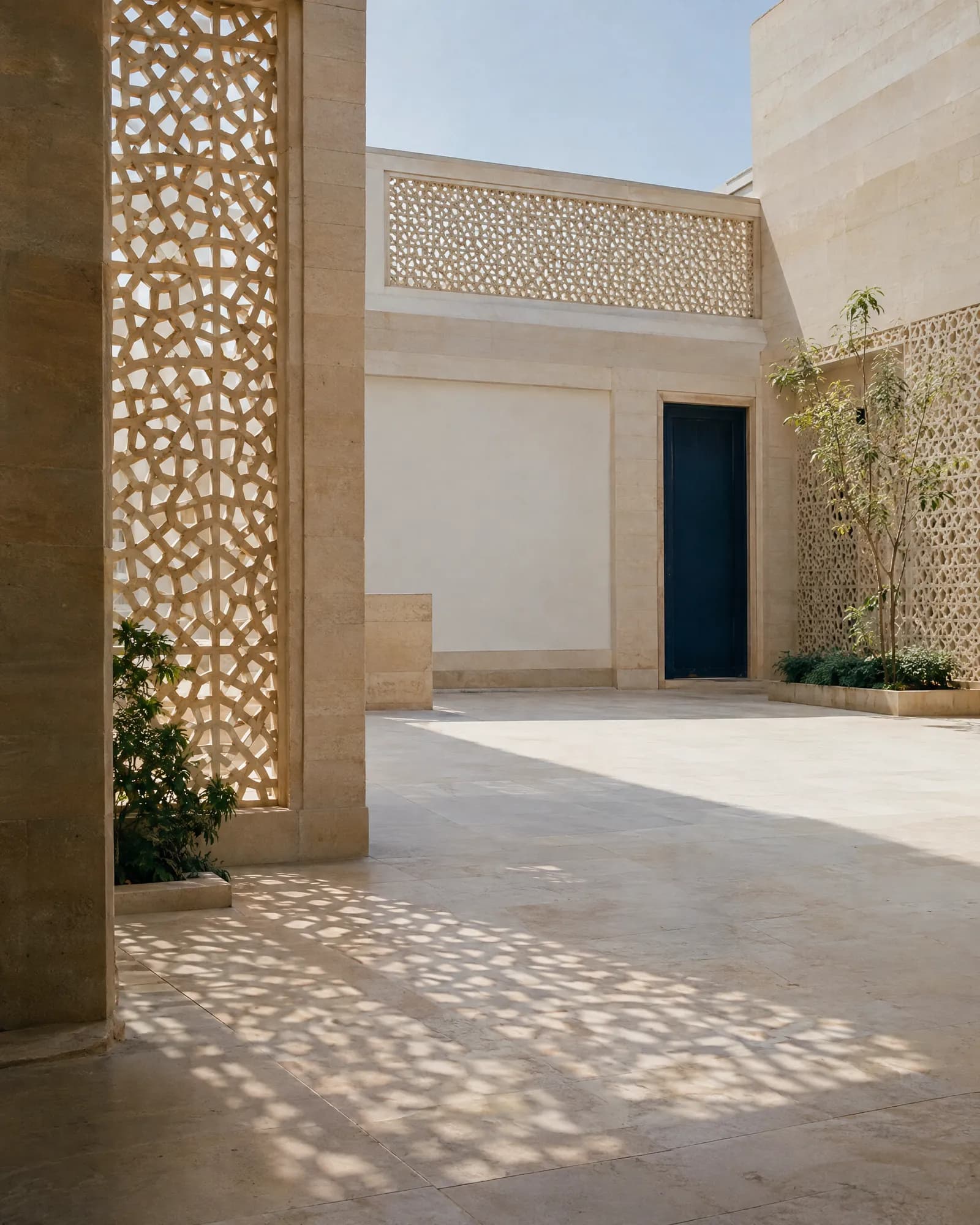 Sunlit courtyard with carved stone jali screens, India